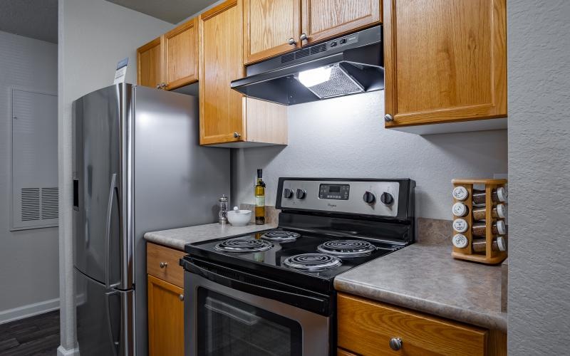 a kitchen with wooden cabinets