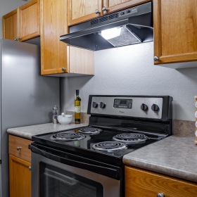 a kitchen with wooden cabinets