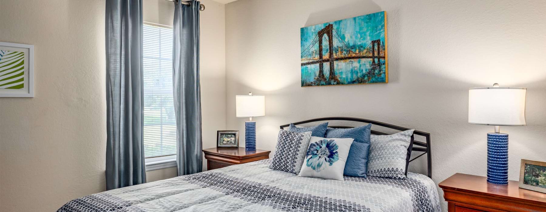a bed with blue and white pillows