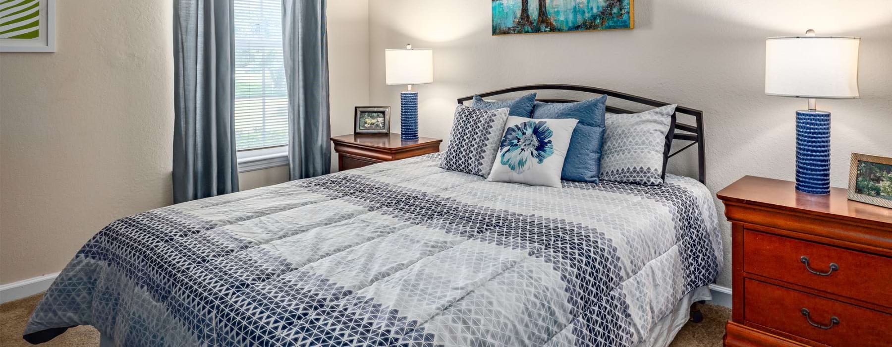 a bed with blue and white pillows