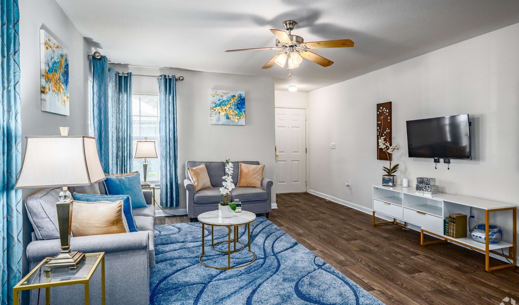 a living room with a blue rug